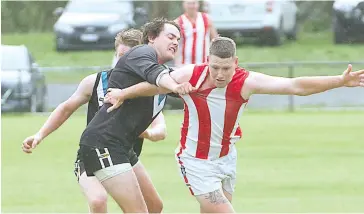  ??  ?? Steven Dillon holds Austin Byrne away from the footy as Yarragon try to wrestle their way back into the contest. Photos - MICHAEL ROBINSON