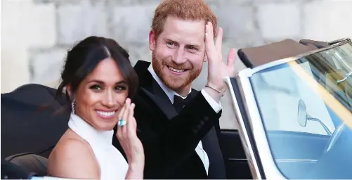  ??  ?? Ready to party: Harry opens the door of the Jaguar for Meghan (left) as they leave the castle for Saturday’s evening do