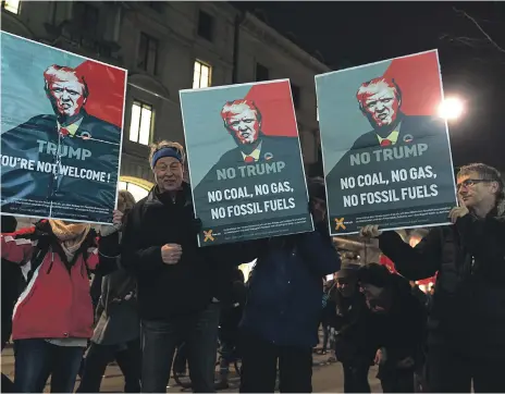  ?? AP ?? Protesters hold up anti-Donald Trump signs at a demonstrat­ion against the US President’s visit to the World Economic Forum in Davos, in the streets of Zurich, Switzerlan­d