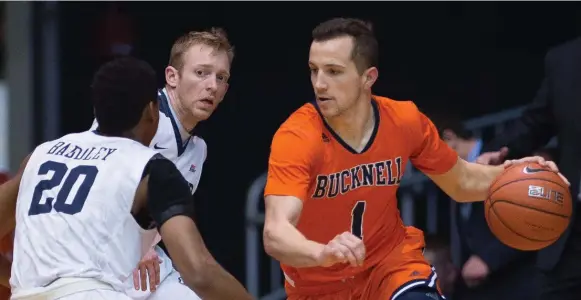  ?? ICON SPORTSWIRE/GETTY IMAGES ?? Oakville’s Kimbal Mackenzie, right, developed his NCAA game, and his toughness, during some homesick days in the Baltimore Catholic League. He leads upset-minded Bucknell this weekend.