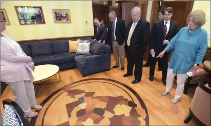  ??  ?? This Aug. 6, photo made available by the West Virginia Legislatur­e shows members of the West Virginia House Judiciary Committee looking at a $7,500 floor map in the office of West Virginia Supreme Court Justice Allen Loughry in Charleston, WV. The House of Delegates approved impeachmen­t articles against justices Allen Loughry, Margaret Workman, Robin Davis and Beth Walker. PERRY BENNETT/ WEST VIRGINIA LEGISLATUR­E VIA AP