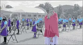  ??  ?? Above: St. Mary Catholic School fifth-graders perform “Silent Night” with sign language. At left: St. Mary Catholic School Celebrates the Opening School Mass outdoors.