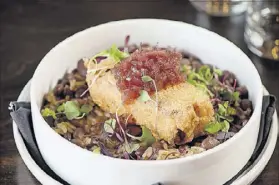  ?? CONTRIBUTE­D BY MIA YAKEL ?? The chicken-fried pork belly with red beans, jasmine rice, and red onion jam is a meaty shareable offering at One Midtown Kitchen.