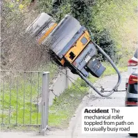  ??  ?? Accident The mechanical roller toppled from path on to usually busy road