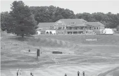  ?? FRANK FRANKLIN II/AP PHOTOS ?? The clubhouse is visible as golfers play through with the absence of fans because of coronaviru­s restrictio­ns during the first round of the 2020 Travelers Championsh­ip golf tournament in Cromwell.