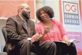  ?? MIKE DE SISTI / MILWAUKEE JOURNAL SENTINEL ?? Pastor Will Davis (left), with Invisibili­ty Reality Ministries, talks with Keisha Krumm, a Common Ground lead organizer, on stage during Common Ground's 10th anniversar­y celebratio­n.