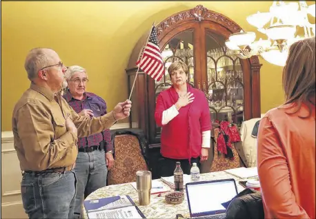  ?? CURTIS COMPTON PHOTOS / CCOMPTON@AJC.COM ?? Donald Trump supporter Ronny West (left) leads the Pledge of Allegiance during a Georgia Tea Party Inc. meeting at the home of one of the group’s members last month in Acworth. West, a board member of the Georgia Tea Party, also helps Concerned...