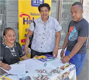  ?? Photo: Shratika Naidu ?? Consumer Council of Fiji Labasa officer Nanise Veikoso (left) assisting two consumers Iowana Timaletila­u and Suliano Jime (right) with their queries at the back to school mobile unit in front of Janta Tek Limited in Labasa on January 8, 2017.