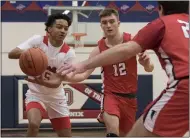  ?? JENNIFER FORBUS — FOR THE MORNING JOURNAL ?? Oberlin’s Marius Harrell looks for room with a pair of Firelands players closing in on Jan. 15.