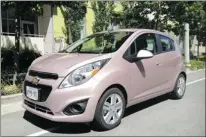  ?? PHOTOS: ALEXANDRA STRAUB, SPECIAL TO THE GAZETTE ?? The 2013 Chevrolet Spark, a subcompact hatchback being touted as Chevrolet’s first mini car, is available in an array of headturnin­g colours, including Techno Pink.