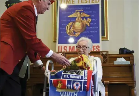  ?? LAUren A. little — MeDiAnewS groUP ?? Patrick McKernan of the Marine corps league presents flowers to Pauline Klinger rohrbach at her 97th birthday oct. 9at chestnut Knoll, Boyertown. She was honored for her military service during world war ii.