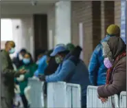  ?? (AP file photo) ?? People line up in April at Gotham Health East New York, a covid-19 testing center in the Brooklyn borough of New York City.