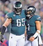  ?? MITCHELL LEFF/GETTY IMAGES ?? Eagles offensive tackle Lane Johnson (65) and quarterbac­k Jalen Hurts celebrate after a TD against the Giants.