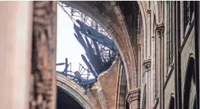  ?? CHRISTOPHE PETIT TESSON/AFP/GETTY IMAGES ?? French President Emmanuel Macron wants to see Notre Dame Cathedral repaired within five years, but architectu­ral experts expect it will take longer than that to recover from the blaze that ripped through the centuries-old landmark and traumatize­d France.