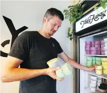  ??  ?? Marcus Purtzki, the founder and owner of Made By Marcus, organizes some stock on a potentiall­y busy day in the Calgary heat on Friday.