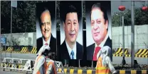  ?? PICTURE: AP ?? Municipal workers in Islamabad, Pakistan walk past a billboard showing pictures of Chinese President Xi Jinping, centre, with Pakistan’s President Mamnoon Hussain, left, and Prime Minister Nawaz Sharif during a recent visit by the Chinese president to...