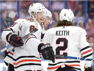  ?? AP ?? Dominik Kubalik (8) celebrates one of his three third-period goals with teammates Jonathan Toews and Duncan Keith on Thursday.