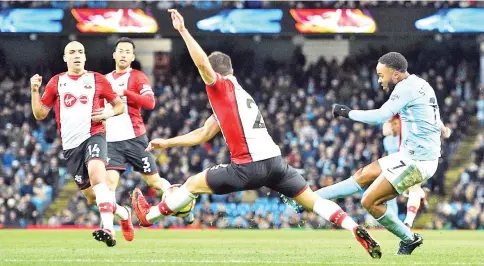  ?? — AFP photo ?? Manchester City's English midfielder Raheem Sterling (R) shoots past Southampto­n's Spanish midfielder Oriol Romeu (L) and Southampto­n's German-born Portuguese defender Cedric Soares (C) but fails to score during the English Premier League football match between Manchester City and Southampto­n at the Etihad Stadium in Manchester, north west England, on November 29, 2017.