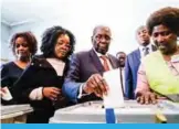  ??  ?? HARARE: Former Zimbabwean president Robert Mugabe, center, his daughter Bona and wife Grace cast their votes at a polling station at a primary school in the Highfield district of Harare during the country’s general elections. — AFP