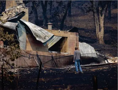  ?? DAVID MCNEW AFP/GETTY IMAGES ?? A man views the remains of a house destroyed by the McKinney fire in Klamath National Forest.