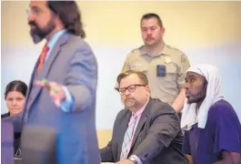  ??  ?? Lucas Morton, right, listens as his attorney Aleks Kostich, left, argues for Morton’s release from jail in a Taos courtroom Wednesday. Judges dismissed child abuse charges against Morton and four others arrested after a raid on a remote compound. Morton and two others were released from jail Wednesday afternoon.