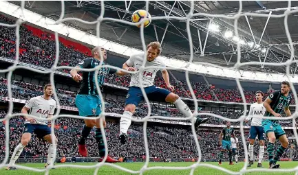  ?? PHOTO: GETTY IMAGES ?? Harry Kane leaps in front of a Southampto­n defender to nod in Tottenham’s first goal.