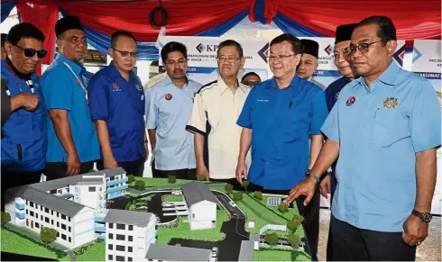  ??  ?? Paving the way for education: Mohamed Khaled (right) viewing a model of Sekolah Agama Kerajaan Negeri Johor Taman Bukit Mutiara during a groundbrea­king ceremony for the school in Johor Baru last month.