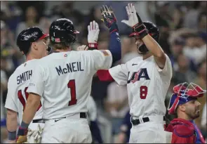  ?? (AP/Wilfredo Lee) ?? Trea Turner (right) celebrates at home plate after hitting his second home run of the game, scoring Jeff McNeil (1) and Will Smith during the sixth inning of a World Baseball Classic semifinal game against Cuba on Sunday in Miami. He became the first player in WBC history to drive in at least four runs in back-to-back games and the second American player to homer twice in a WBC game.