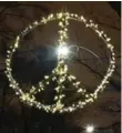  ?? RENÉ JOHNSTON/TORONTO STAR ?? Andrew Fraser creates a new, 1- 1⁄2- storey design each year and this Christmas dedicated his efforts to a peace sign, seen as a symbol of global unity in the aftermath of the terrorist attacks in Paris.