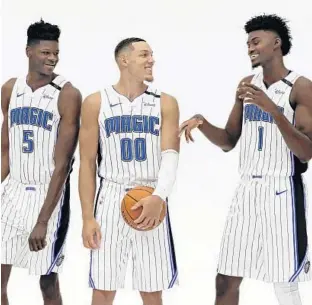  ?? JOHN RAOUX/ASSOCIATED PRESS ?? Mohamed Bamba (5), Aaron Gordon (00) and Jonathan Isaac give the Magic three players with tremendous defensive upside and that could go a long way as the team looks to forge a tougher identity.