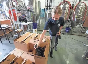  ?? SHAWN DOWD/USA TODAY NETWORK ?? Haley Balcomb fills cases with Black Is Beautiful Imperial Stout as the beer is bottled at Mortalis Brewing Company in Avon, N.Y.