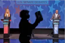 ?? AP PHOTO/BEN GRAY, POOL ?? U.S. Sen. Kelly Loeffler, left, and Democratic challenger for U.S. Senate Raphael Warnock appear during a debate on Dec. 6 in Atlanta.