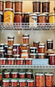  ?? CONTRIBUTE­D BY ASHA GOMEZ ?? Chef and food writer Asha Gomez has a love for preserving food. Pictured here are some of the canned goods in her pantry.