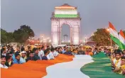  ?? PHOTO: PTI ?? People hold a 200-ft-long Tricolour while taking part in a ‘Tiranga March’ to protest alleged communalis­ation of Kathua rape case, at India Gate in New Delhi on Saturday