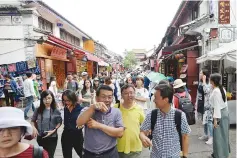  ??  ?? The ancient city of Dali is a popular attraction for domestic and internatio­nal tourists.