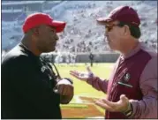  ?? STEVE CANNON — THE ASSOCIATED PRESS ?? In this Nov. 18, 2017, file photo, Florida State’s head coach Jimbo Fisher, right, meets Delaware State’s head coach Kenny Carter at midfield before the start of an NCAA college football game in Tallahasse­e Fla.