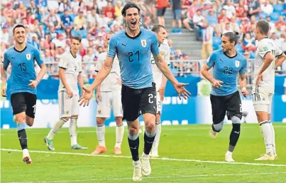 ?? Picture: AP. ?? Edinson Cavani celebrates after making it 3-0 for Uruguay.