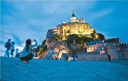  ?? DOMINIC ARIZONA BONUCCELLI/RICK STEVES’ EUROPE ?? Mont Saint-michel is a soaring island abbey in Normandy that is totally surrounded by the sea at high tide.
