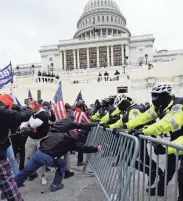  ?? JULIO CORTEZ/AP ?? Rioters attack the Capitol on Jan. 6 in Washington.