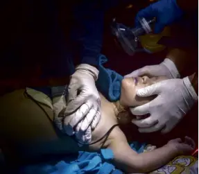  ?? AP ?? MEDICAL personnel try to revive a child rescued from a sunken boat off the Greek island of Lesbos. The condition of the child is not known.