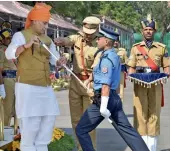  ?? — PTI ?? Rajnath Singh presents sword of honour to Rajesh Raj Puri at the parade at Sardar Vallabhbha­i Patel National Police Academy in Hyderabad on Monday.