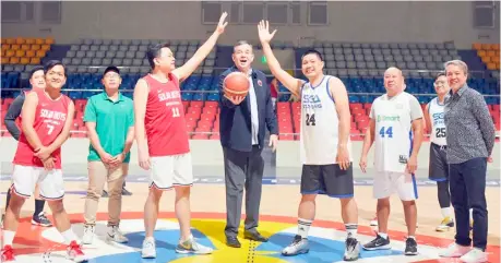  ?? PHOTOGRAPH COURTESY OF PSA ?? PHILIPPINE Sports Commission chairman Richard ‘Dickie’ Bachmann makes the ceremonial jump ball to kick off the PSA Cup last Tuesday at the Ninoy Aquino Stadium. Also shown is ACES president Ian Laurel (right).
