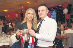  ?? (Pic: Catherine Sheehan) ?? Laura Slyne and Barry Coffey proudly hold the All-Ireland club hurling trophy at Friday’s social.