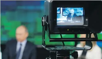  ?? YURI KOCHETKOV/ THE ASSOCIATED PRESS FILES ?? Russian President Vladimir Putin is shown on the screen of a camera viewfinder at Russia Today. Russia has assembled a giant media machine the West wants to counter.