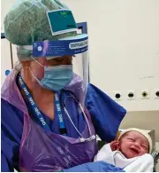  ??  ?? Just born: Life Goes On, taken by Matthew Williams, shows his son with the midwife