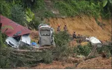  ?? VINCENT THIAN — THE ASSOCIATED PRESS ?? Rescue teams continue the search for victims caught in a landslide Saturday in Batang Kali, Malaysia.