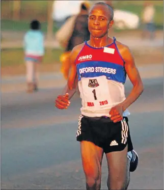  ?? Picture: FREDLIN ADRIAAN ?? BIG STRIDES: Lusapho April on his way to victory in the City of Champions Youth Challenge 10km road race in Zwide at the weekend