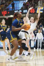  ?? AP PHOTO/KATHY KMONICEK ?? UTC forward Raven Thompson prepares to shoot against Wofford guard Helen Matthews during the SoCon tournament title game on March 5 in Asheville, N.C. By winning the league championsh­ip, UTC returned to the NCAA tourney for the first time since 2017.
