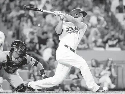  ?? Jae C. Hong Associated Press ?? COREY SEAGER FOLLOWS THROUGH on a single in the third inning at Dodger Stadium against Tampa Bay’s Chris Archer. Seager’s hit drove in Joc Pederson for the first run of the game and was the 46th RBI of the season for the rookie shortstop.