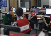  ??  ?? From left to right, Emergency Operations Center employees Lauren Zieff, Joshua Bertain and Sabrina Cardoza discuss emergency related matters.